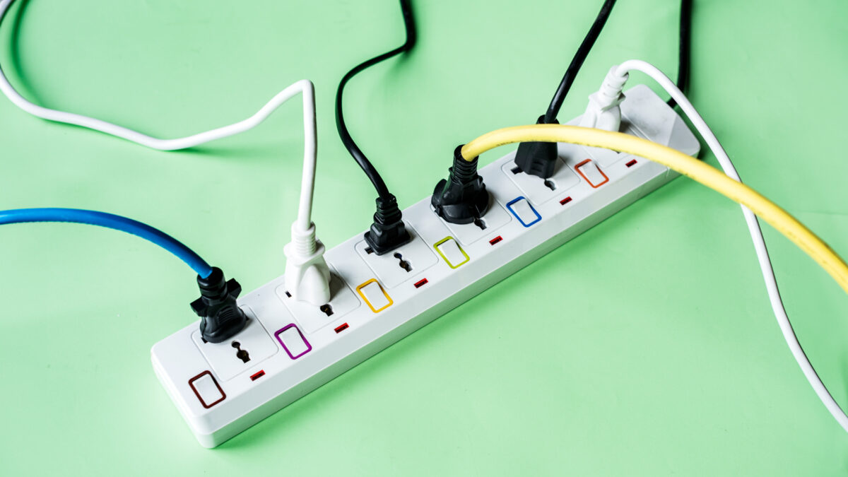 A power strip with several electrical cords plugged in, showcasing multiple devices connected for power supply.