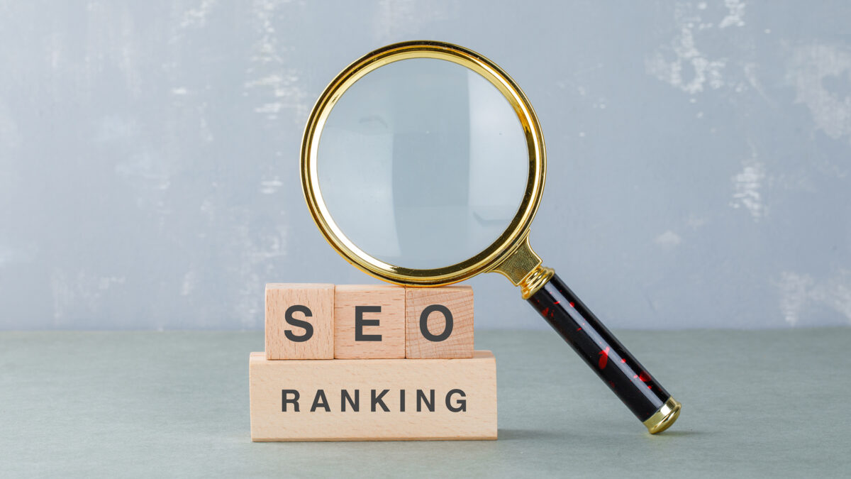 A visual representation of SEO ranking, featuring a block and a magnifying glass, symbolizing search optimization efforts