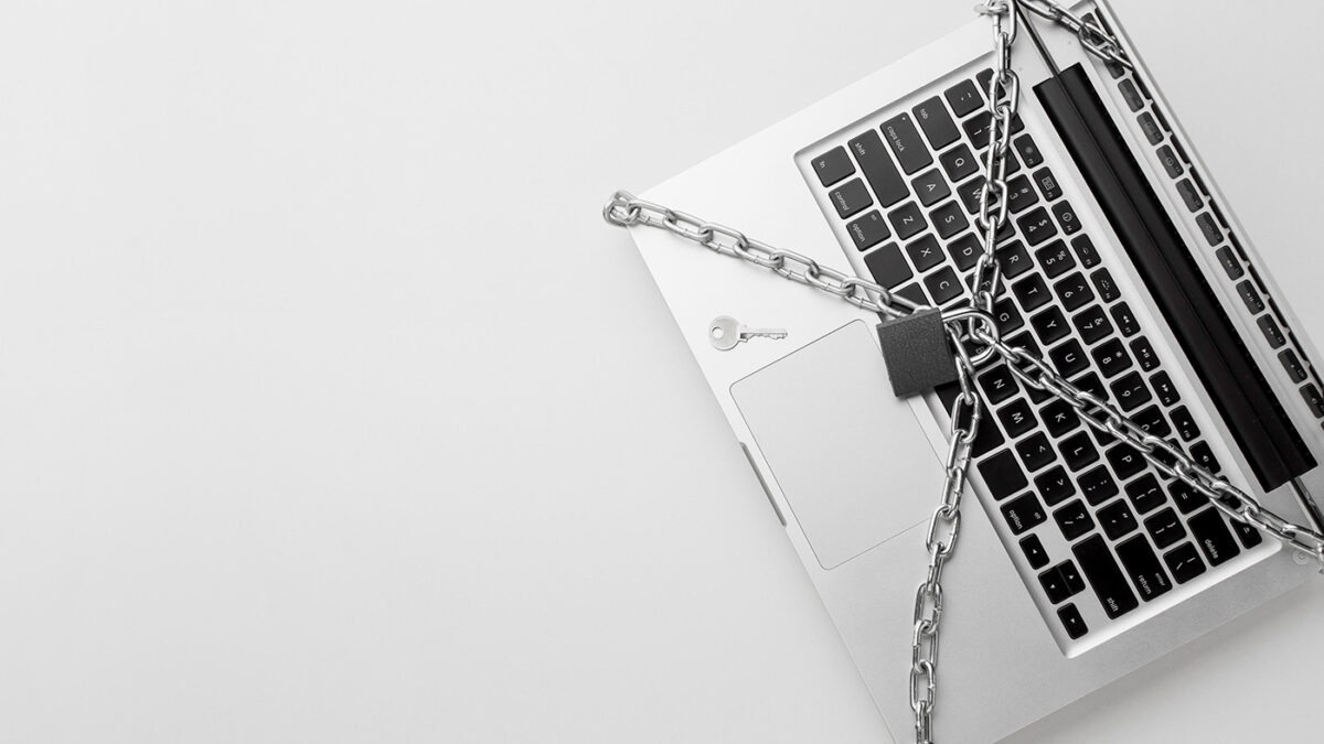 A laptop secured with a chain and padlock, symbolizing data protection and cybersecurity measures